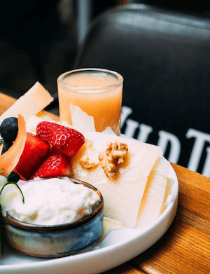 piatto colazione con fragole formaggi e succo di frutta