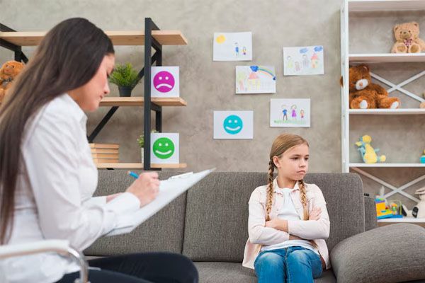 ragazza con un'espressione triste mentre il dottore prende appunti