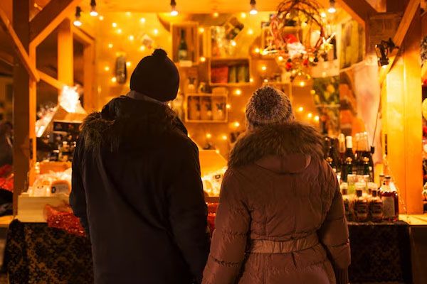 coppia felice abbraccia il mercatino di Natale