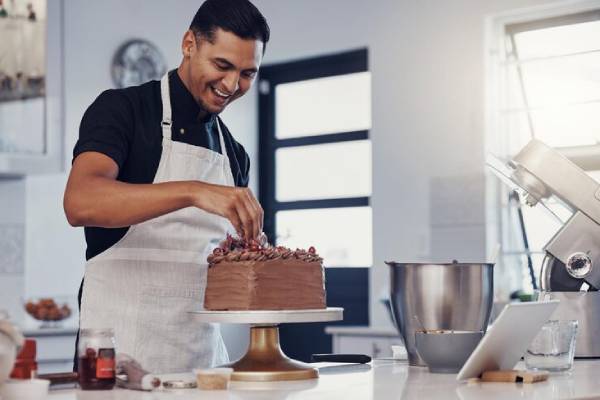 Primo piano di una coppia di novelli sposi che tagliano la torta nuziale